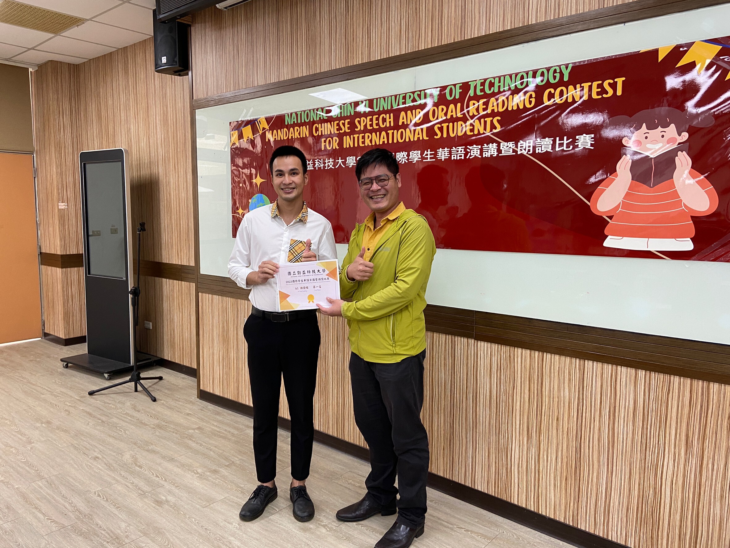 4th set of two people stand together with a cert document on their hand